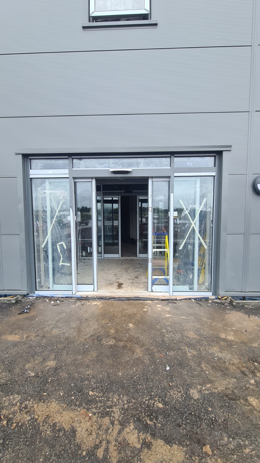 Automatic sliding door entrance installed on an industrial building